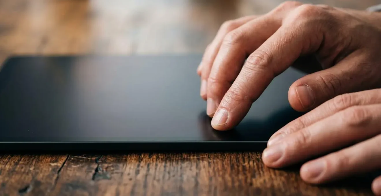 Close-up of hands practicing accounting software training on tablet device