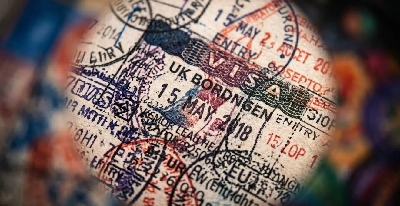 Extreme close-up of interconnected passport stamps showing tax complexity